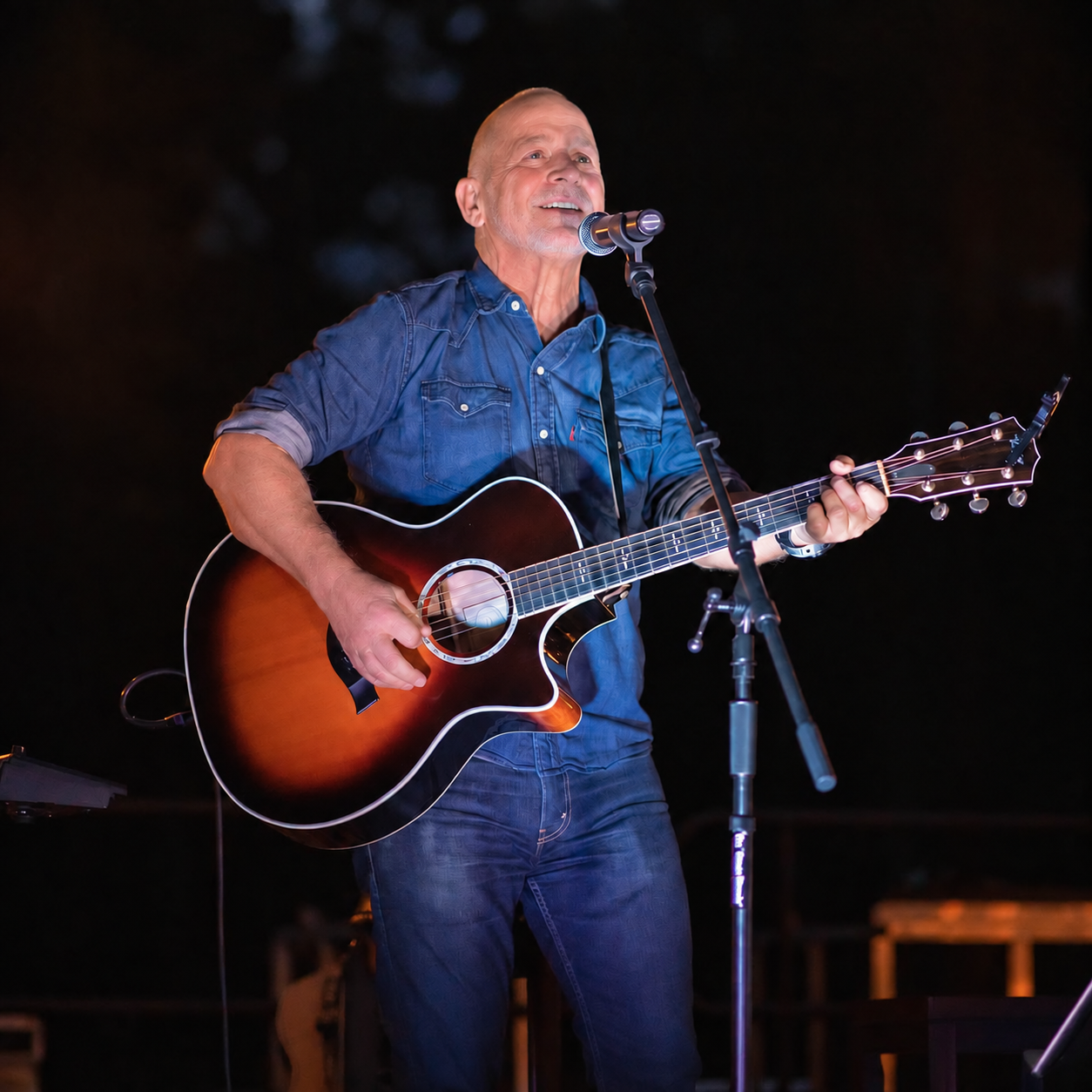 Danny Dukes performing live with an acoustic guitar